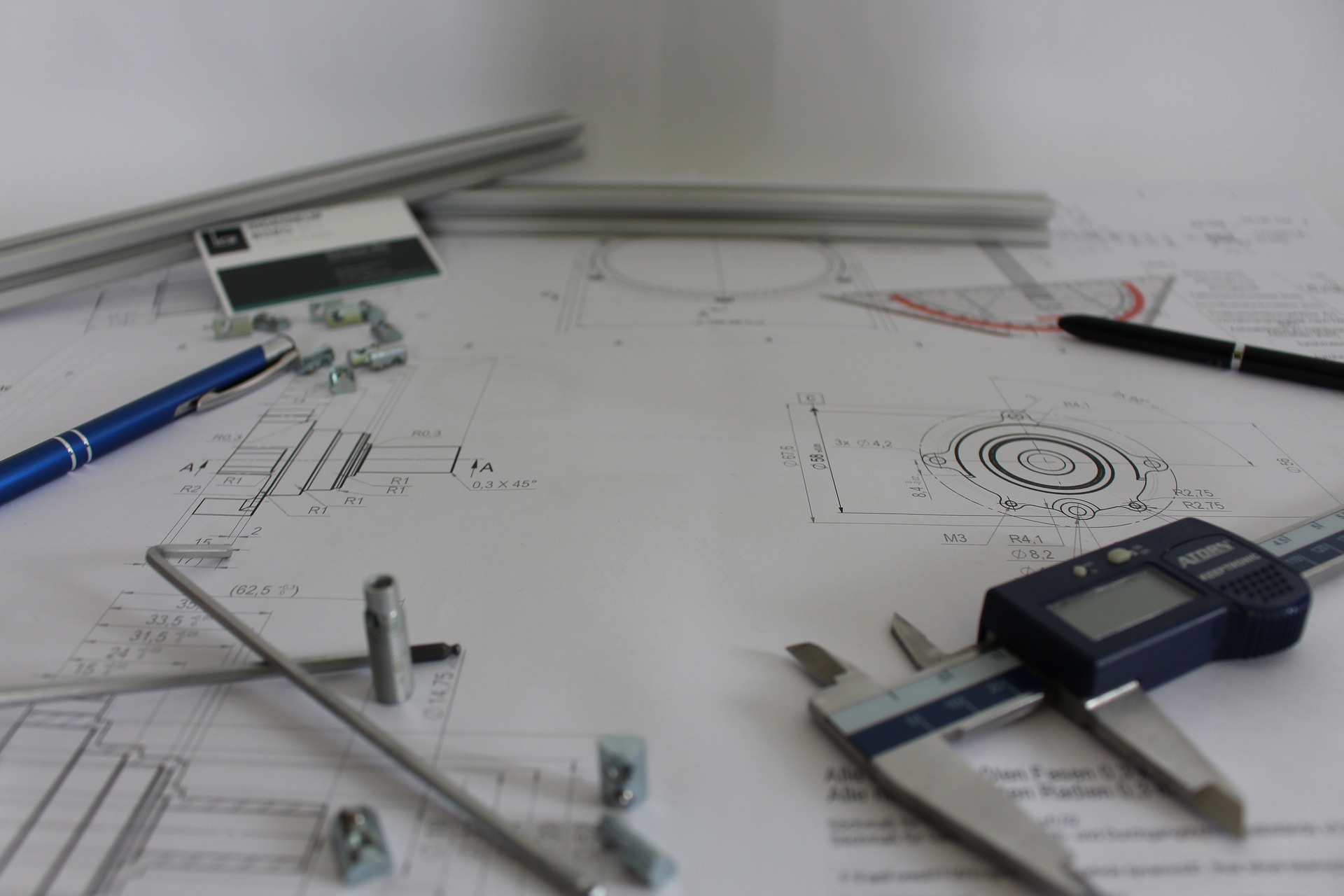 What I as a layperson imagine an engineer's workspace might look like: paper! pencil! calipers! CAD diagrams!